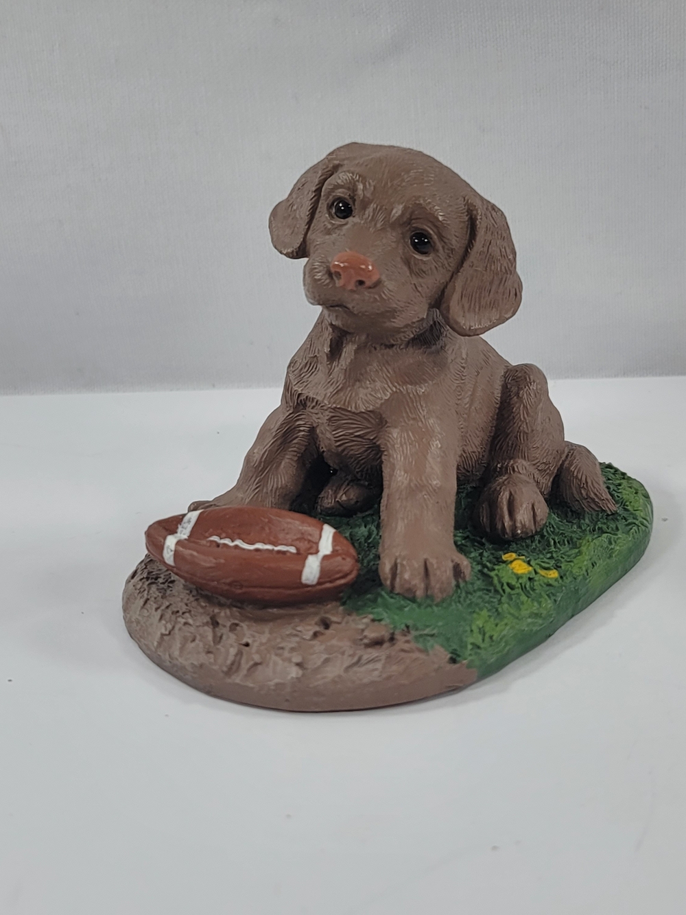 Chocolate Labrador Puppy With Football Figurine